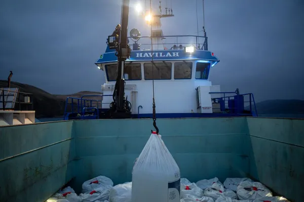 Salmon feed being lifted onto a feed barge